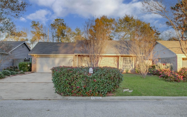 ranch-style house with a front yard and a garage