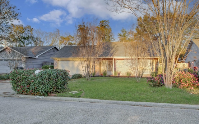 view of front of house featuring a garage and a front lawn