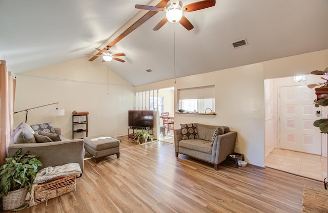 living room featuring light wood-type flooring, lofted ceiling with beams, and ceiling fan