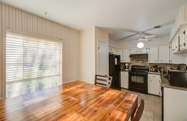 kitchen with stone counters, white cabinetry, ceiling fan, tasteful backsplash, and black appliances