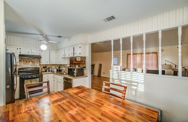 kitchen with black appliances, white cabinets, sink, decorative backsplash, and ceiling fan