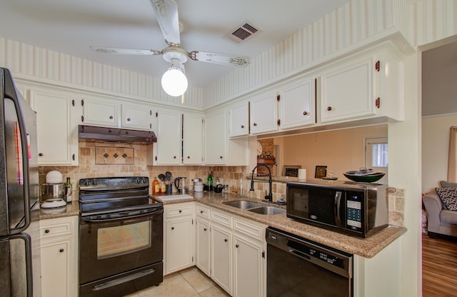 kitchen featuring white cabinets, sink, and black appliances