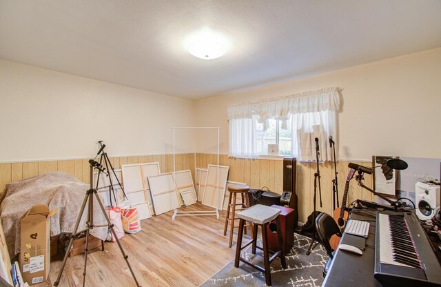 exercise room with wood walls and hardwood / wood-style floors