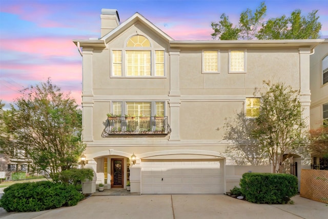 view of front of house with a balcony and a garage