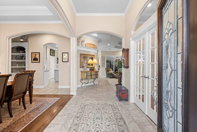 entryway featuring french doors, light hardwood / wood-style floors, and crown molding