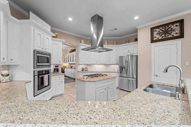 kitchen featuring appliances with stainless steel finishes, island range hood, white cabinetry, and sink