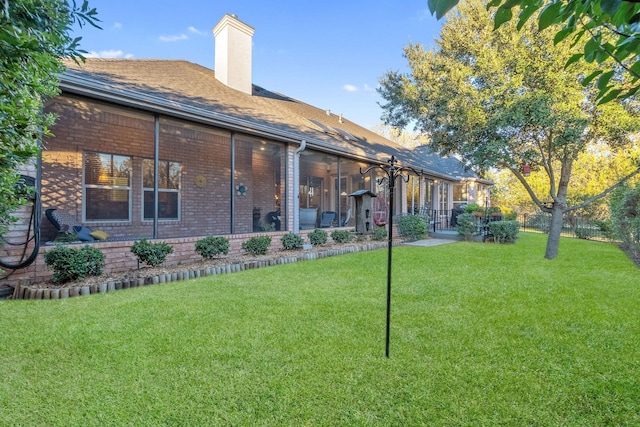 back of house with a lawn