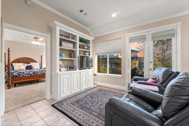 living room with crown molding, ceiling fan, plenty of natural light, and light colored carpet