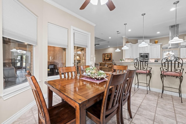 dining room with ceiling fan, light tile patterned floors, and crown molding