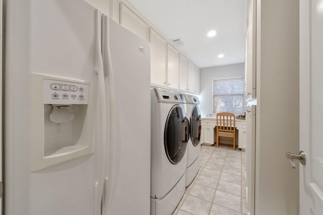 clothes washing area featuring cabinets and independent washer and dryer