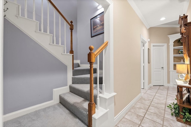 stairs with tile patterned flooring, vaulted ceiling, and ornamental molding