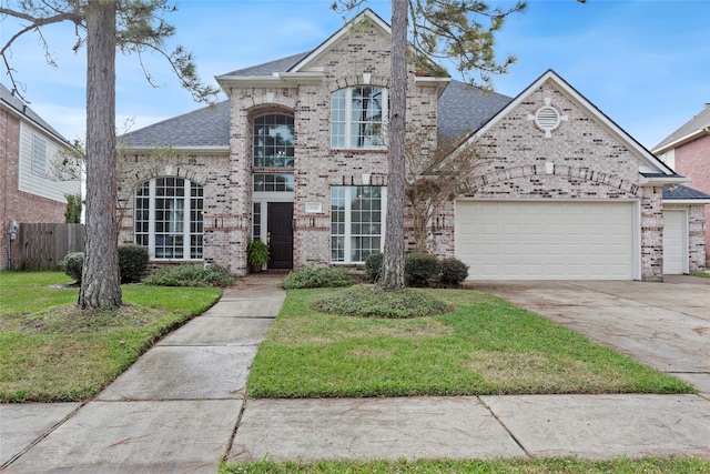 view of front of property with a garage and a front lawn