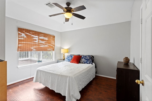 bedroom with ceiling fan and dark hardwood / wood-style flooring