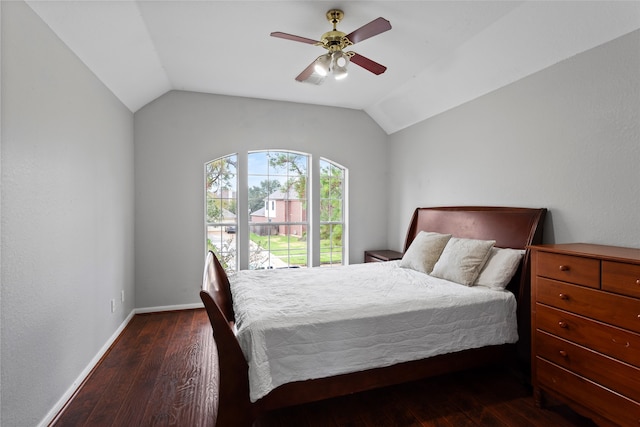 bedroom featuring ceiling fan, dark hardwood / wood-style floors, and vaulted ceiling