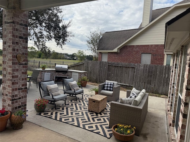 view of patio featuring grilling area, an outdoor kitchen, and an outdoor hangout area