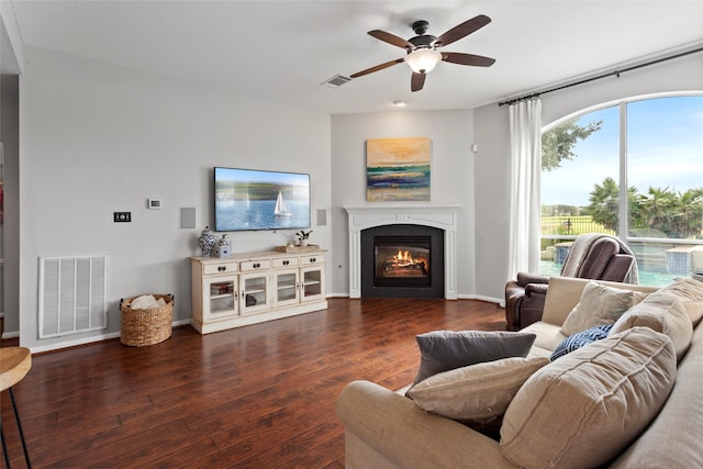 living room with dark hardwood / wood-style floors and ceiling fan