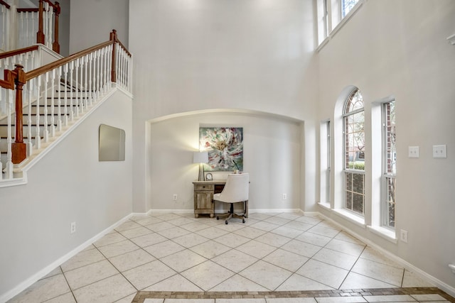 entrance foyer with a high ceiling and light tile patterned floors