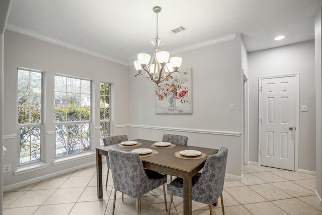 tiled dining space featuring crown molding and an inviting chandelier