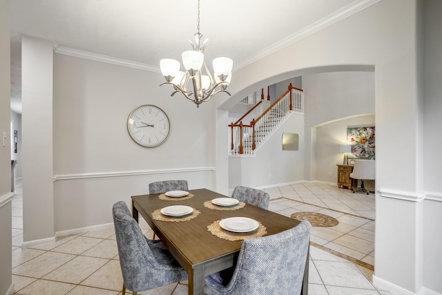 tiled dining area with crown molding and a chandelier