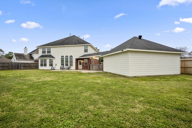 rear view of property featuring a patio area and a lawn