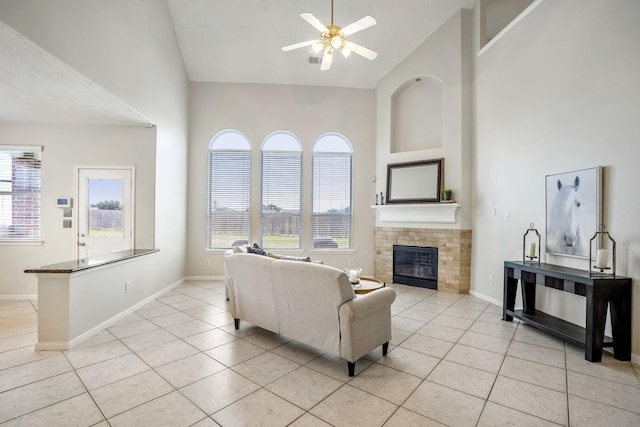 living room featuring light tile patterned floors, plenty of natural light, and high vaulted ceiling