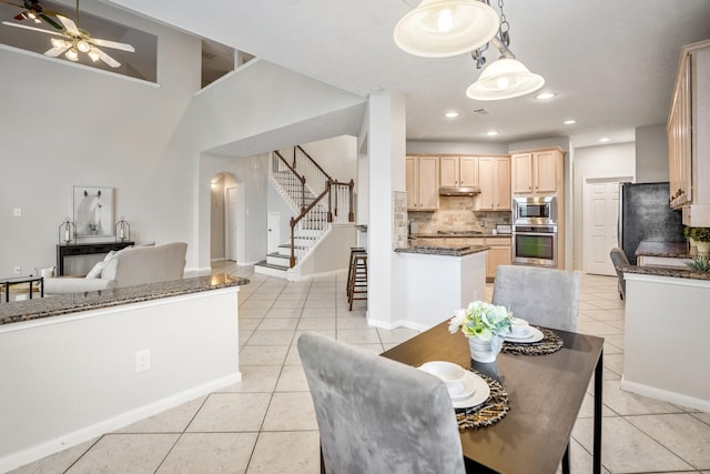 dining space featuring light tile patterned floors and ceiling fan