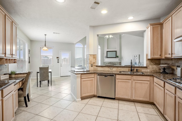 kitchen featuring decorative light fixtures, dishwasher, sink, and light brown cabinets