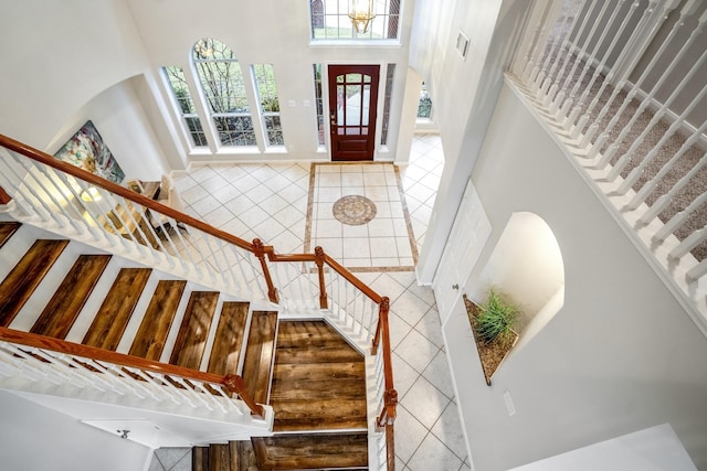 tiled foyer entrance with a towering ceiling