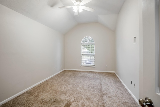 carpeted spare room with vaulted ceiling and ceiling fan