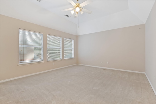 carpeted spare room with ceiling fan and vaulted ceiling