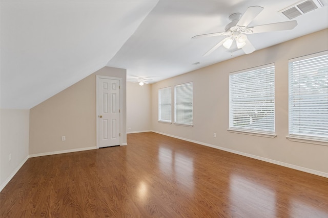 bonus room featuring hardwood / wood-style floors, vaulted ceiling, ceiling fan, and a healthy amount of sunlight