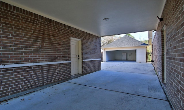 view of patio / terrace with an outdoor structure and a garage