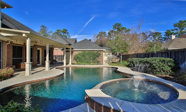 view of pool featuring an in ground hot tub, pool water feature, ceiling fan, and a patio area