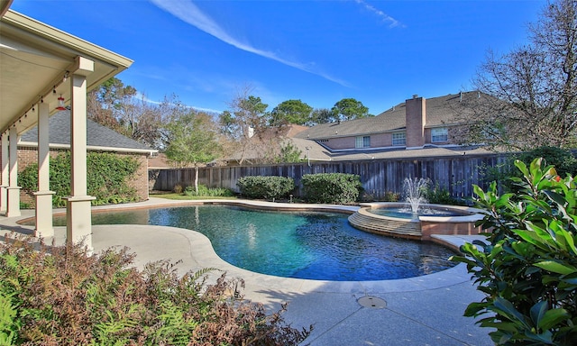 view of swimming pool featuring an in ground hot tub, pool water feature, and a patio