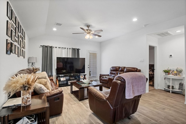 living room with light hardwood / wood-style flooring, ceiling fan, and lofted ceiling