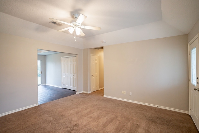 carpeted spare room with ceiling fan