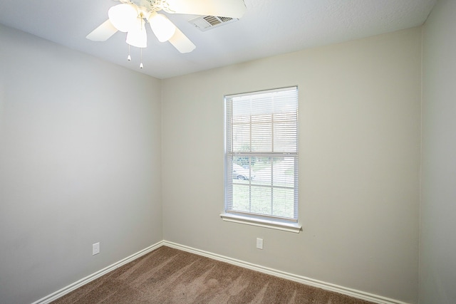 unfurnished room featuring carpet floors, a wealth of natural light, and ceiling fan