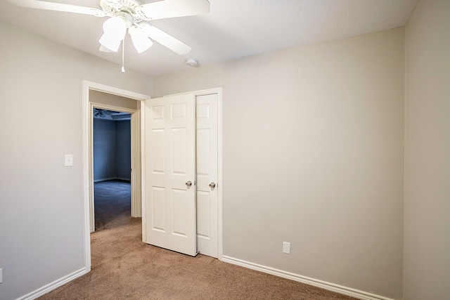 carpeted empty room with ceiling fan