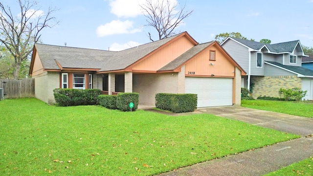 view of front of house with a garage and a front lawn