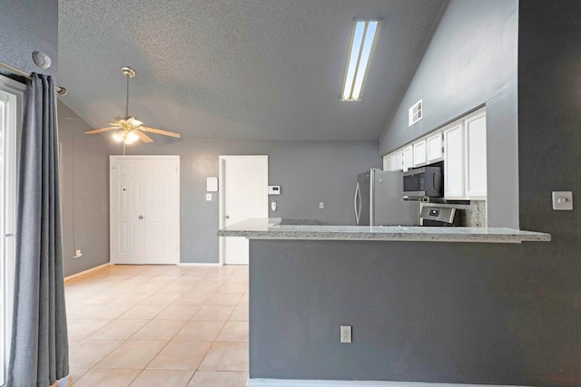 kitchen featuring white cabinets, vaulted ceiling, stainless steel appliances, and kitchen peninsula