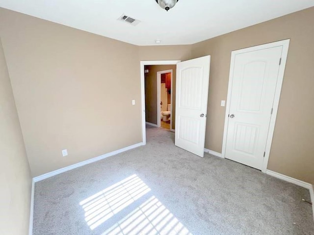 unfurnished bedroom featuring light carpet