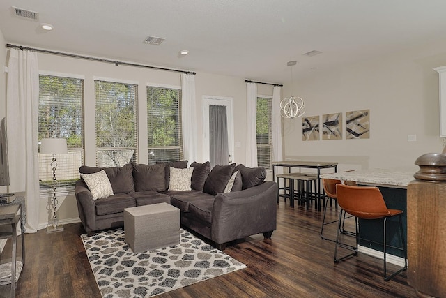 living room featuring dark hardwood / wood-style floors and plenty of natural light