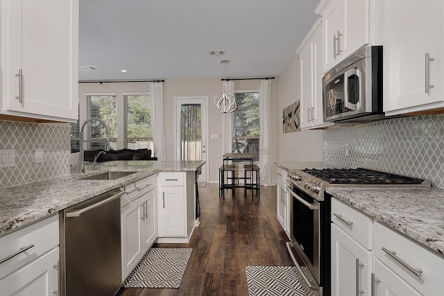 kitchen with sink, white cabinetry, stainless steel appliances, and dark wood-type flooring