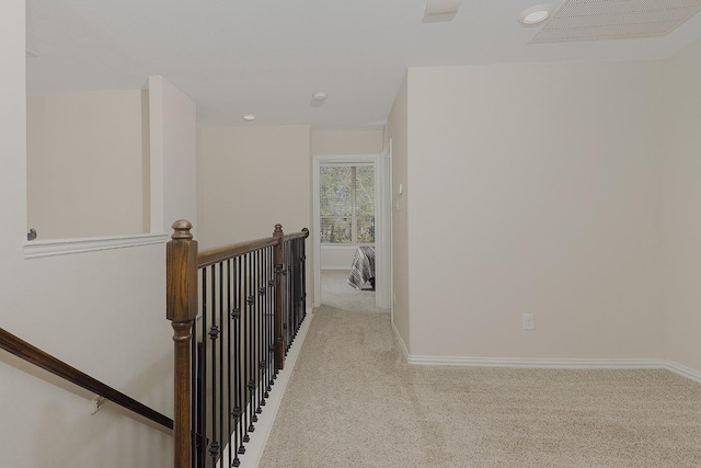 corridor with light colored carpet