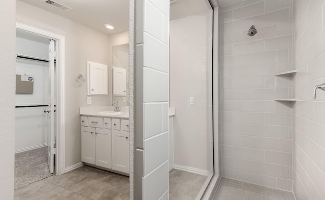 bathroom featuring vanity and tiled shower