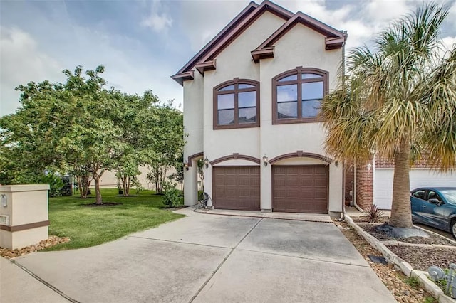 mediterranean / spanish home with a front yard and a garage