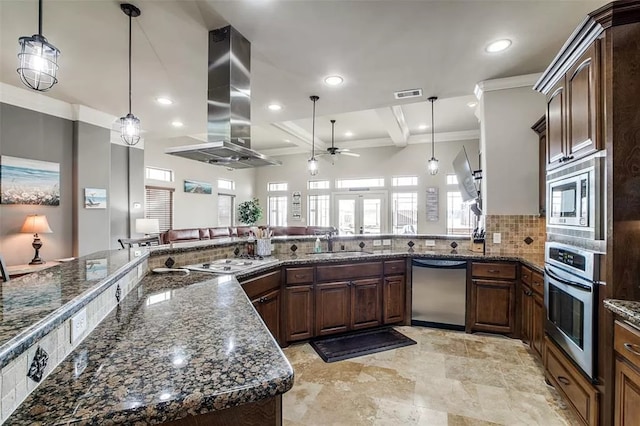 kitchen with island range hood, pendant lighting, beamed ceiling, and stainless steel appliances