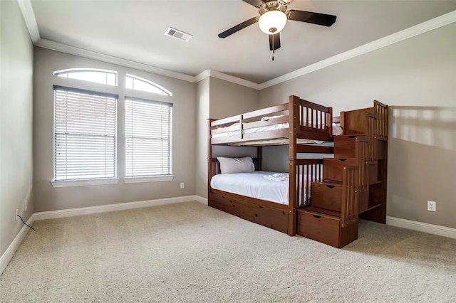 unfurnished bedroom with carpet flooring, ceiling fan, and crown molding