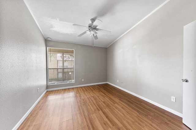 empty room featuring hardwood / wood-style flooring, ceiling fan, and a textured ceiling