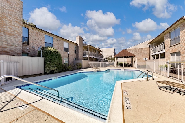 view of pool featuring a gazebo and a patio